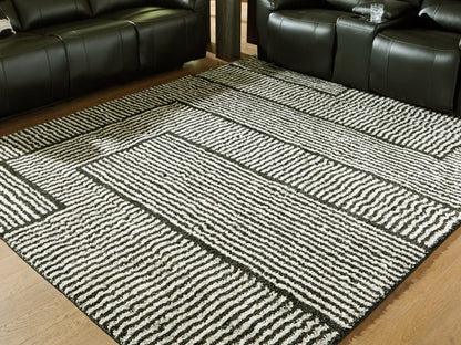 Pines Furniture Outlet - Ashley Furniture - Kurtmen Rug - 5' x 7' Area Rug / Black/Ivory - R407592